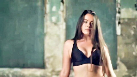 Brunette in plunging black bra, sexy photo shoot pose