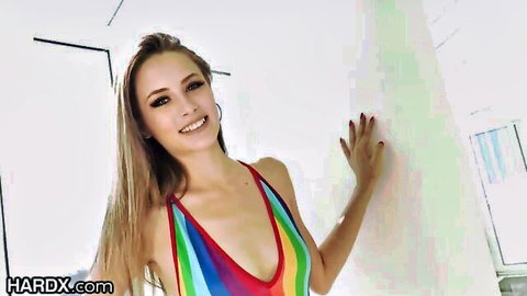 Kyler Quinn smiling in colorful sling bikini, long blonde hair