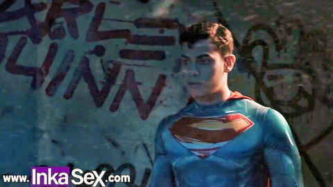 Sexy Superman cosplay hunk in tight blue suit posing against graffiti wall
