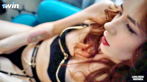 Seductive Asian redhead in black gold-chain lingerie, posing erotically