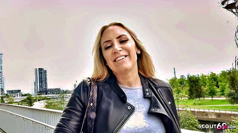 Blonde MILF Karlie Simon smiling in leather jacket at street casting pickup