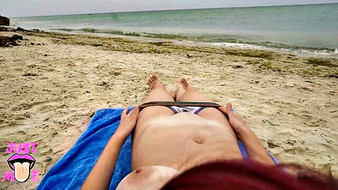 Topless redhead with big tits pulls down striped bikini exposing shaved pussy on beach towel