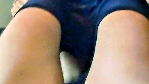 Closeup of woman's wet shaved pussy exposed with creamy discharge in pulled-aside blue shorts, thighs spread wide