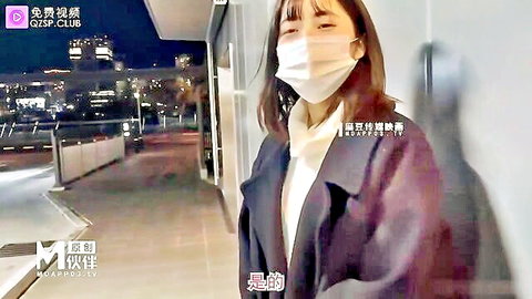 Masked Asian woman in coat outdoors at night, JAV solo scene