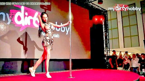 Skinny Asian babe in skimpy fringed thong bikini pole dancing on stage teasing her tight body