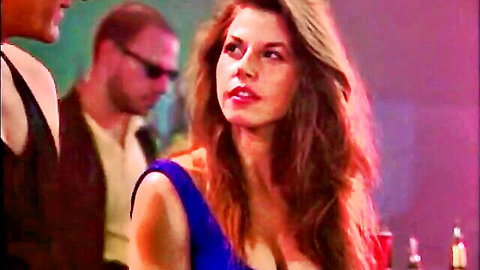 Brunette in sexy blue dress with cleavage at bar, classic Catwoman vibe