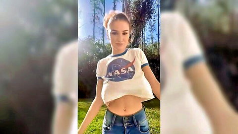 Blonde with big tits in tight NASA tee posing outdoors
