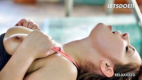 Brunette squeezes her exposed small tits poolside with mouth open in ecstasy