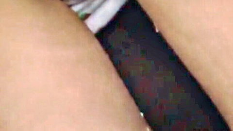 Closeup of shaved Asian pussy penetrated by thick black dildo with black stockings and white garters