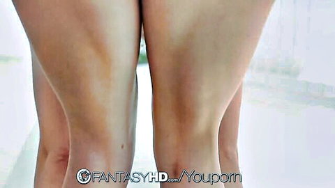Two nude brunettes standing rear view exposing toned thighs and round asses