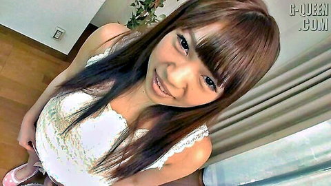 Cute smiling Asian brunette teen in low-cut lacy white top showing deep cleavage