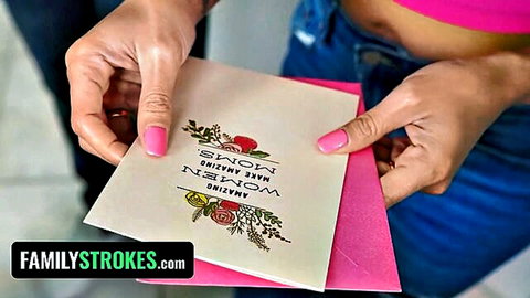 Stepmom's hands with pink nails holding 'New Mom' card in pink top and jeans FamilyStrokes taboo