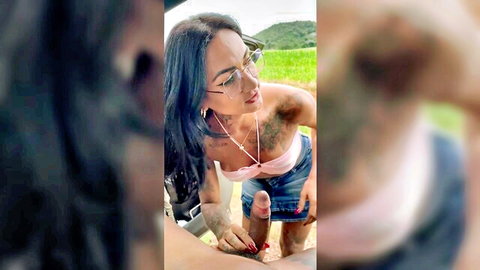 Brunette in glasses gives roadside blowjob outdoors by car, explicit oral action