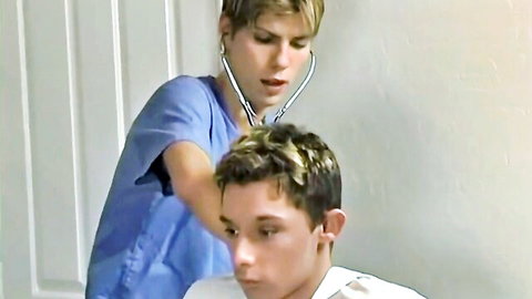 Blonde twink doctor in scrubs examining patient with stethoscope