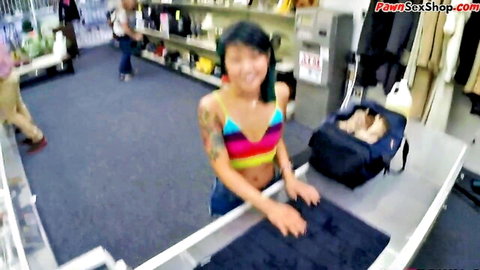 Tattooed Asian woman in pawnshop teasing with blowjob and doggystyle action