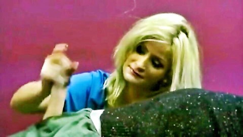 Blonde woman in blue top giving intense handjob to erect cock