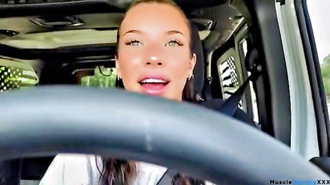 Beautiful brunette smiling in car, low-cut white top teasing cleavage before boob job