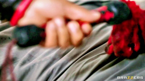 Andrews in control with red BDSM floggers, dominating tease