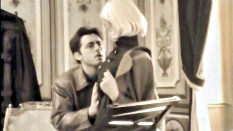 Mature blonde German cougar in lingerie touches young man's collar intimately