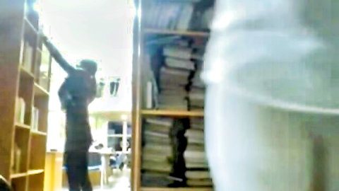 Babe flashing bare ass bending over reaching for books on library shelves