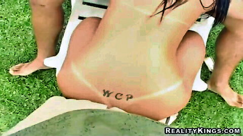 Tanned brunette bent over lounge chair outdoors exposing ass and pussy for threesome doggy style fuck
