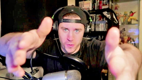 CEO in black cap and headphones gestures in streaming setup for catgirl handjob video