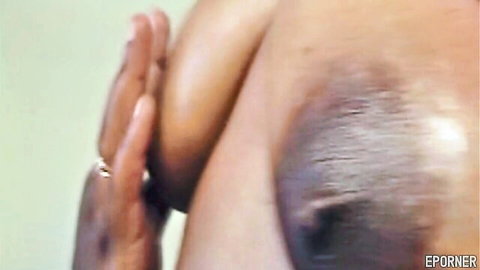 Ebony BBW squeezes her massive dark tit and erect nipple closeup