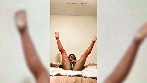 Ebony sissy in red stockings spreading legs wide exposing pussy for training