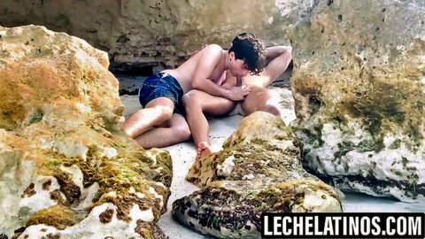 Marcos and Latino partner in intimate beach embrace, LecheLatinos gay scene