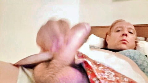 Redhead teases erect cock with foot on bed, closeup orgasm tease