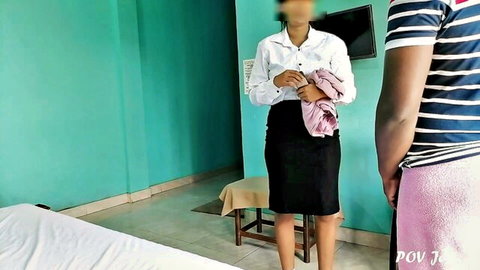 Sri Lankan hotel maid in white blouse and black skirt stands with guest in POV tease