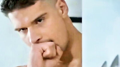 Muscular Caucasian man with intense gaze, shirtless in gay adult video