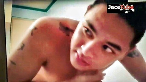 Shirtless Asian man with tattoos posing seductively in Sarap video