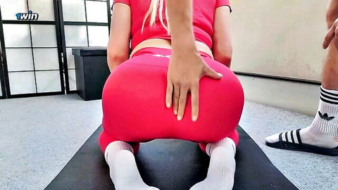 Blonde in tight red leggings kneels doggystyle as guy squeezes her big round ass cheeks