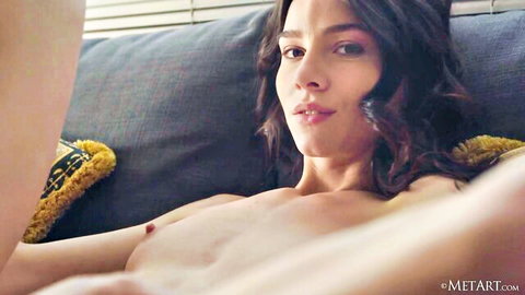 Brunette babe with perky tits and erect nipples lounging topless on couch