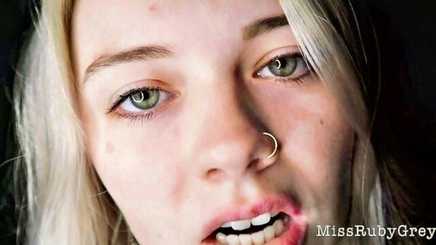 Miss Ruby Grey blonde model with green eyes, nose piercing, and open mouth in teasing pose