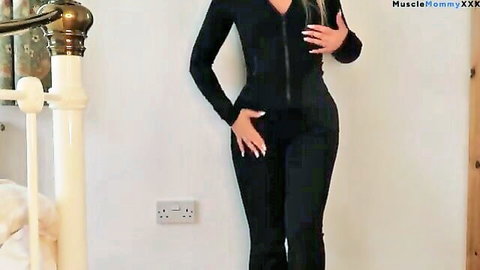 Blonde fitness babe in tight black zip-up gym bodysuit try-on pose