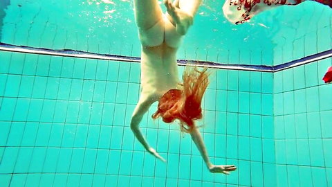 Redhead European model diving nude underwater, bare ass exposed