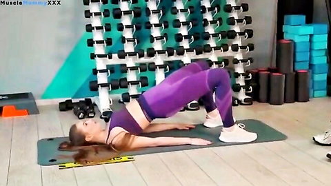 Stunning athletic model in purple leggings doing bridge stretch yoga pose