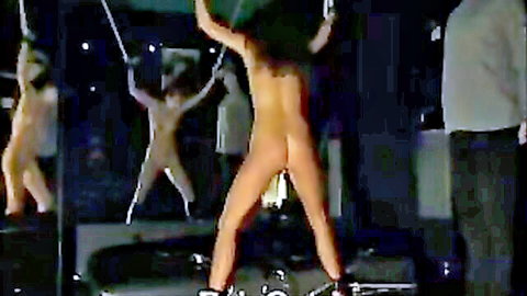 Flexible slender nude woman in bondage pose, shaved pussy visible in mirrors