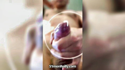 Manicured hand gripping thick veiny purple uncut dildo close-up