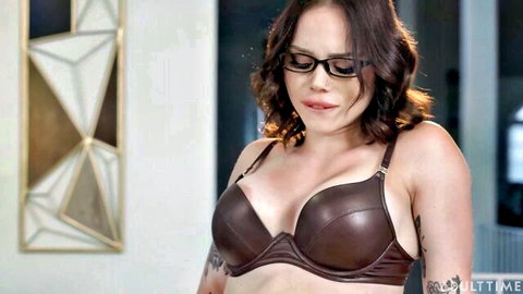 Katerina DeVille in sexy brown leather bra, teasing cleavage