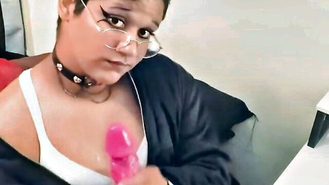 FemboyFever transgender girl in glasses and robe holds pink dildo