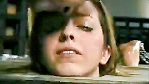 Brunette model hogtied and submerged in white liquid for intense BDSM treatment