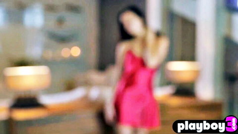 Stunning Asian babe in pink slip dress posing seductively
