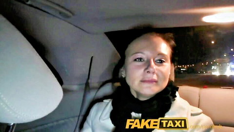 Enza in white coat with black fur scarf in FakeTaxi cab, seductive gaze