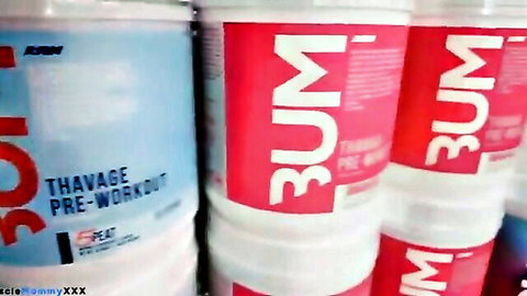 Shelves of pre-workout supplements at Absolute Recomp Gym, Dallas
