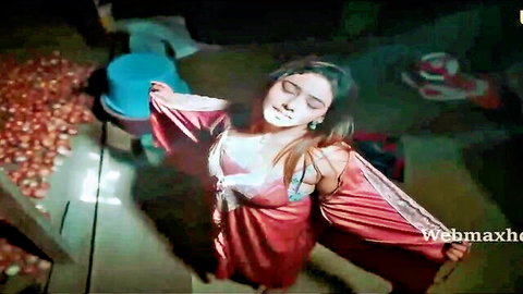 Seductive Indian woman in flowing red silk dress, arms outstretched