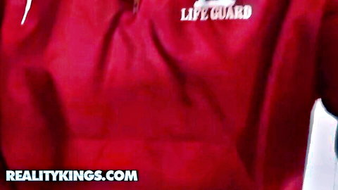 Kelly Ann in sexy red lifeguard jacket showing deep cleavage