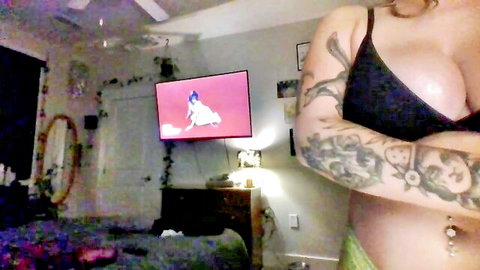 fairygodmother777 blonde tattooed cam girl in black bra cleavage pose